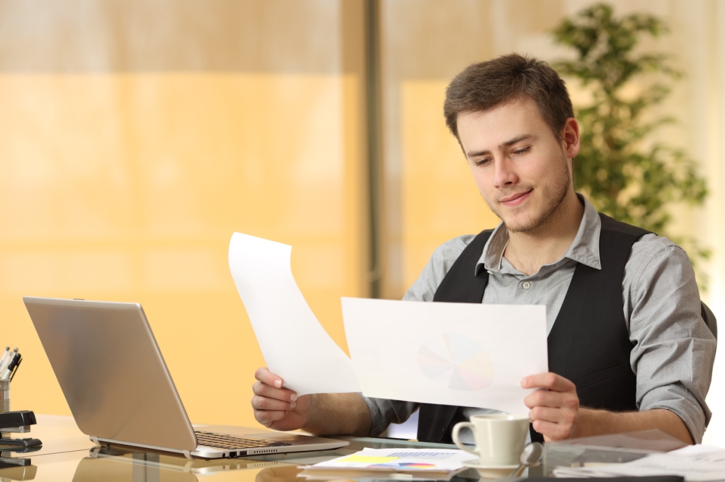 businessman-browsing-through-financial-documents-in-an-office-at-his-desk-inflation-concept